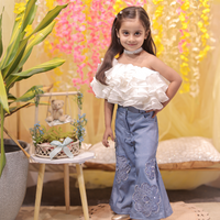 White ruffled top with stylish denims