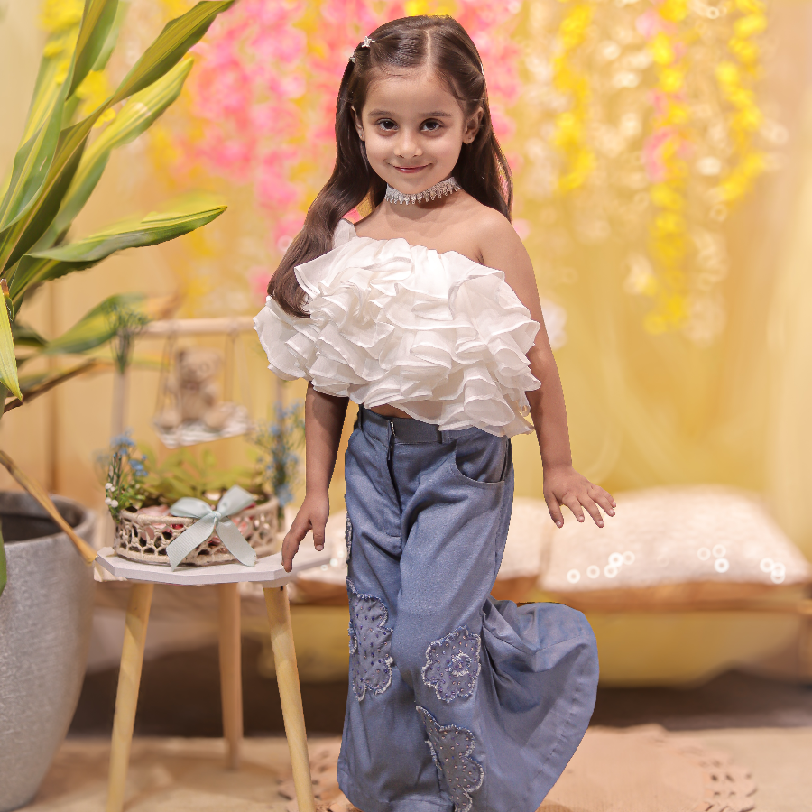 White ruffled top with stylish denims