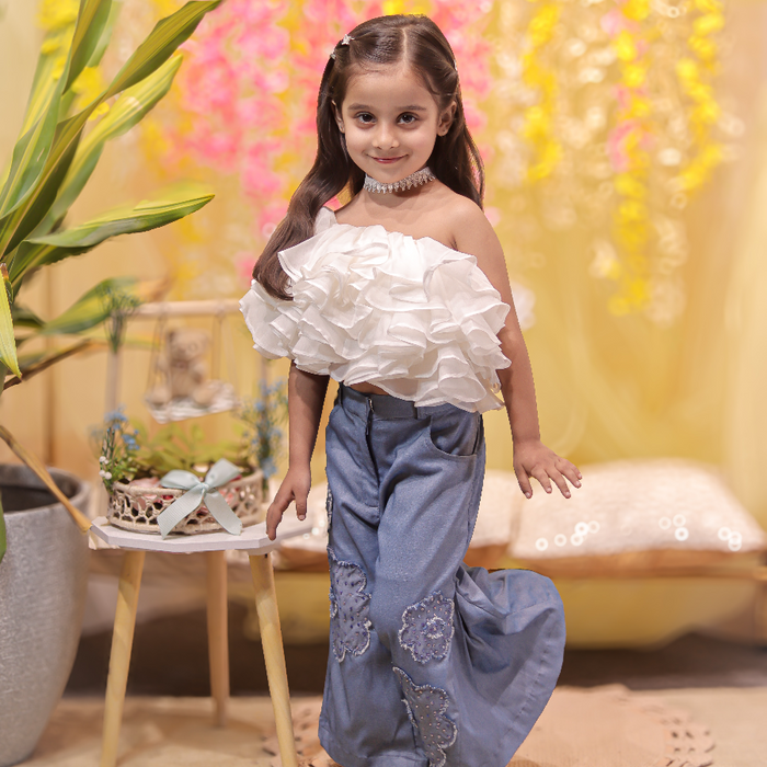 White ruffled top with stylish denims