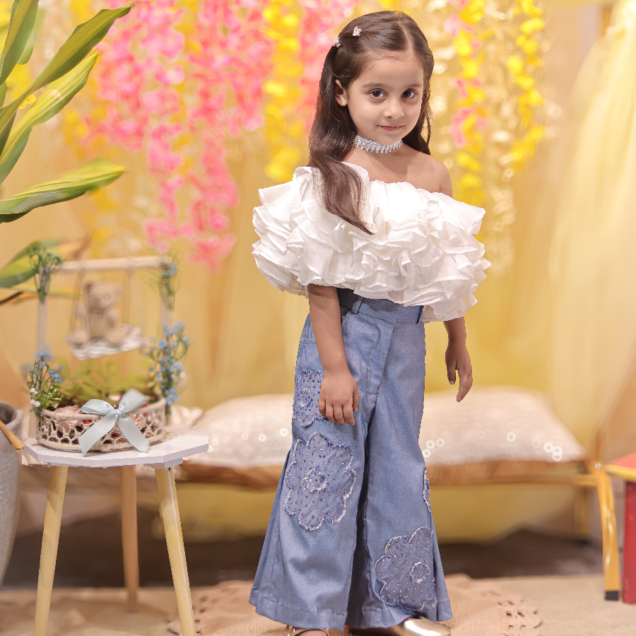 White ruffled top with stylish denims
