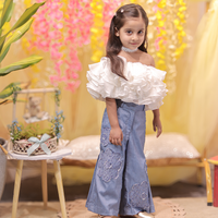 White ruffled top with stylish denims
