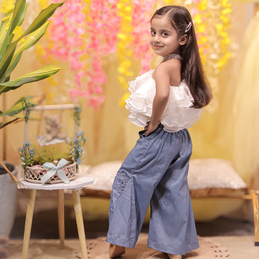 White ruffled top with stylish denims